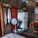 The interiors of the house. The two curtains separate the bedroom and kitchen. The red curtain is the kitchen entrance.