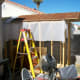 A vinyl drop cloth was draped over the rafters to direct any leakage to the outside wall