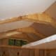View of ceiling showing concept of double insulation. Used scraps of insulation to seal off attic so air conditioner could be used while installing insulation in walls.