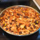 Cooked Spicy Vegetarian Chili with Cabbage and Black Beans in skillet.