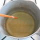 Once the wax melts to a clear liquid, remove it from the heat.