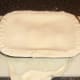 Pastry is trimmed around edges of pie dish