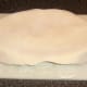 Pastry is carefully fitted on to the top of the pork, apple and pineapple pie