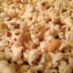 Put your popcorn into a large baking dish. If you are adding peanuts, you'll want to add them at this step.
