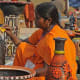 An artist giving finishing touches to her clay pottery work