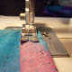 Sew one inch in and then reverse to the end. Then go forward again slowly creating a straight stitch.