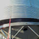 A strap for helping to guide the bin into place on the hopper is bolted in near the bottom.