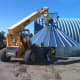 A boom can be extended over the peak of a bin if desired, weighting it against the ground.