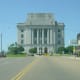 The shared County Courthouse and Post Office straddles the border at one end of State Line Avenue. On the Texas side, alcohol is licensed tand sold, but not on the Arkansas side of town. On the Arkansas side, lottery tickets are legal.