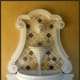 carved stone and yellow and brown tiles set the stage for this water fountain