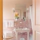Martha Stewart's version of a vintage pink bathroom. Old charm with a few modern twists like pink subway tiles.