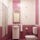 pink bathroom with white fixtures and cabinets