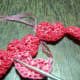 WIP 2 - Pass the plarn underneath the previous heart chain.