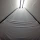 White sheet hanging across the back wall of the loft.