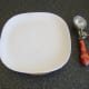 Chilled plate and ice cream scoop ready to drizzle ice cream with chocolate