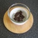 Chocolate is melted in one bowl over another bowl of hot water