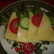 Insert slices of tomato and cucumber between the Gouda cheeses. Ready to eat Graubrot Gouda Cheese bread.