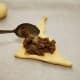Spoon the meat mixture onto one triangle of dough.