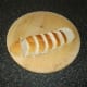 Sub roll is sliced to a thickness of around three-quarters of an inch