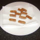 Wee Willie Winkie sausages are drained on kitchen paper after they are fried
