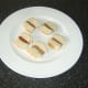 Sausages are skewered between two portions of the sub roll