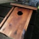 Bird House with front piece positioned for use as a nesting box.