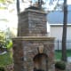 outdoor fire place more formal in design with symmetrical square stones