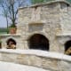 triple sectioned fire place expansive raised hearth with cavities on both sides for storing wood