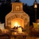 beautiful fire in a a stucco fireplace edged in stone