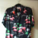 a flamingo shirt with a flamingo pin.