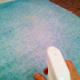 Misting the fabric with water from a spray bottle.