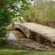 A bridge leading over water separating the two different parks.