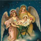 Two vintage angels with baby Jesus, village below
