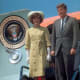 Jackie Kennedy Wearing Gloves in Business Formal Attire Standing with her husband John F Kennedy