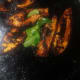 Put some curry leaves and let it fry along with the fish pieces.