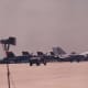 An F-14 with F/A-18s of the Blue Angels in the background, Andrews AFB, MD.