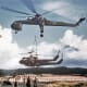 A U.S. Army CH-54 carrying 2 Huey helicopters.