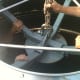 A crew member carefully guides the feet into place against the lower edge of the collar.