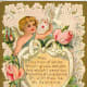 Victorian valentine card with cherub, ribbon heart, white dove, pink roses and lace background