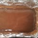 Liquid coconut oil has been mixed with cocoa and agave nectar. The mixture is now ready to go into the freezer.