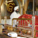 The Guru Granth Sahib, the Holy book of the Sikhs is kept on a manji (throne), on a raised platform in the center of the room. It is covered with a cloth called Rumala Sahib at all times as a mark of respect.