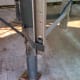 Bolts extend through the leg of the hopper.