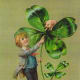 St. Patrick's Day cards: Irish lad with large shamrock and pig "Greetings on St. Patrick's Day"