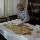 When the wheat is dry, begin to carefully collect it toward the center by raising the edges of the sheet and smoothing the wheat off the sheet to get it nearer to the center or to one spot that's easy to reach.