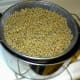 After wheat is well rinsed, put colander over cooking pan to let all the water drain away. While the water drains away, prepare the table.
