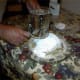 He sifts the sugar over the top and sides so that the mound is covered. Taking the pictures was a great excuse to get him to do this part, since when I put on the nuts and sugar I never seem to get it done to his satisfaction.