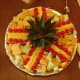 Lay out the pineapple top and the prepared pieces around it.