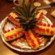 Lay out the pineapple top and the prepared pieces around it.