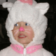 Very simple face paint for a small child. Pink nose and lips, white whiskers.