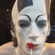 Fantasy face paint design in black and white with kiss painted on lips area